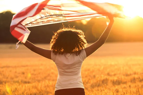 Misturado raça afro-americana menina adolescente com bandeira dos EUA no por do sol — Fotografia de Stock