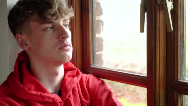 Сумний Підліток Юнак Підліток Червоній Капюшоні Сидить Дивиться Вікно Під — стокове відео