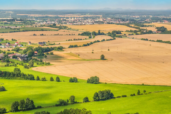 Landscape seen from the air. Fields and villages leading to the horizon.