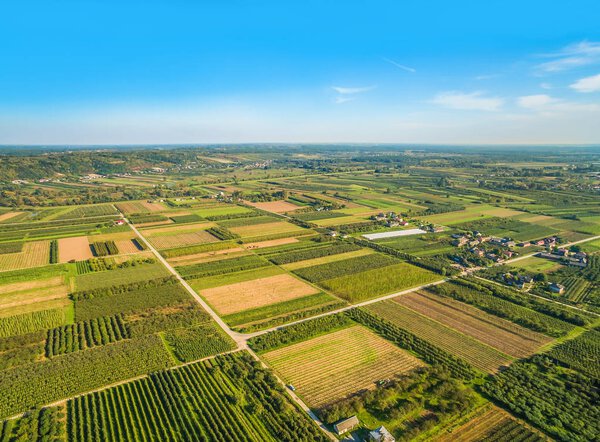 Rural landscape with bird's eye view. Small farmland stretching to the horizon.