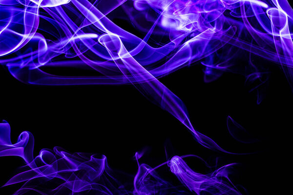 Black background with blue and purple shapes formed from smoke. Abstract forms and free space for text. Smoke - abstract colorful shapes. Black background and fancy shapes.