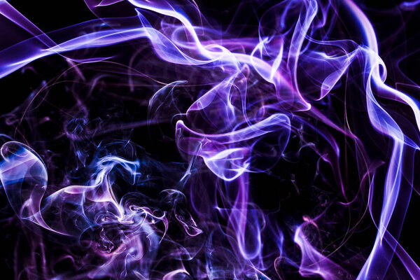 Abstract background. Colorful smoke on a black background. Waves and energy lines. Smoke - abstract colorful shapes. Black background and fancy shapes.
