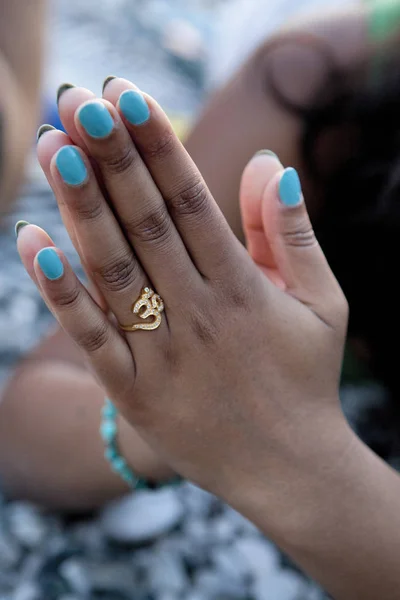 Woman\'s hands , prayer pose, ring om symbol