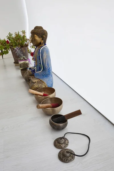 Singing bowls, om tingsha cymbals and buddha statue