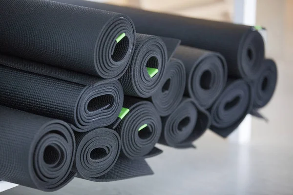 Black yoga mats in yoga studio