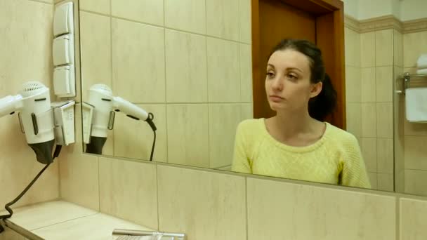 Closeup Portrait of Female Face with Clean Skin in the Mirror. Young Smiling Girl with Dark Curly Hair is Looking at Herself with Pleasure. — Stock Video