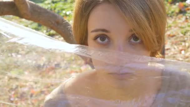 Portrait of beautiful woman in polyethylene wrap. Ecology concept. Natural beauty in plastic world. — Stock Video