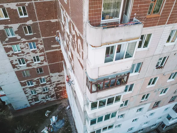 Dos escaladores industriales se calientan en casa. Trabajadores calentando la fachada de un edificio —  Fotos de Stock