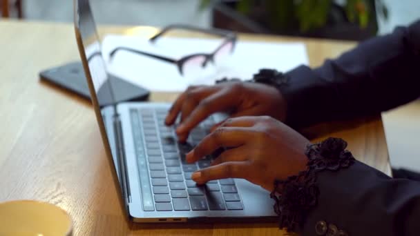 Empresária afro-americana a trabalhar com computadores portáteis e documentos. Mulher ocupada pagando contas bancárias on-line gerenciar finanças verificando orçamento fazendo papelada usando computador sentado na mesa — Vídeo de Stock
