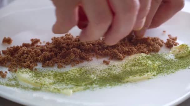 The chef puts the dark rye bread on a plate. Close-up action of hands — 비디오