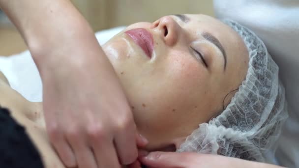 Masážní terapeut provádí manuální masáž obličeje klientů. Pleťová kosmetika. Lázeňská masáž obličeje — Stock video