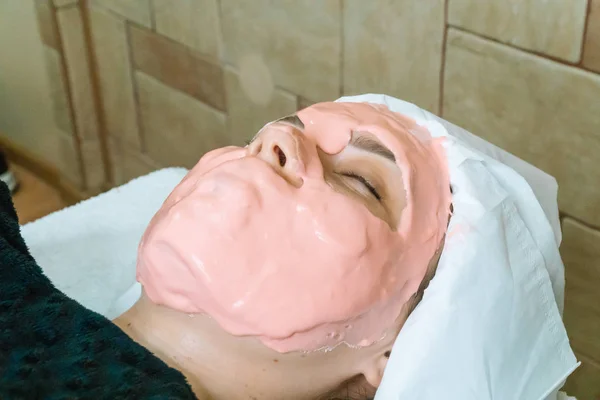 Gadis dengan topeng kosmetik di sebuah salon spa. Aplikasi topeng wajah. Pijat wajah spa — Stok Foto