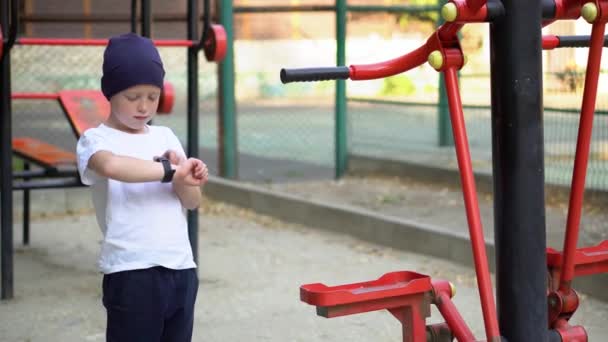 Red hair boy on street public sports training equipment — 비디오