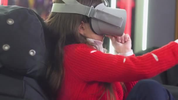 Little girl playing VR simulator with glasses — Stock Video