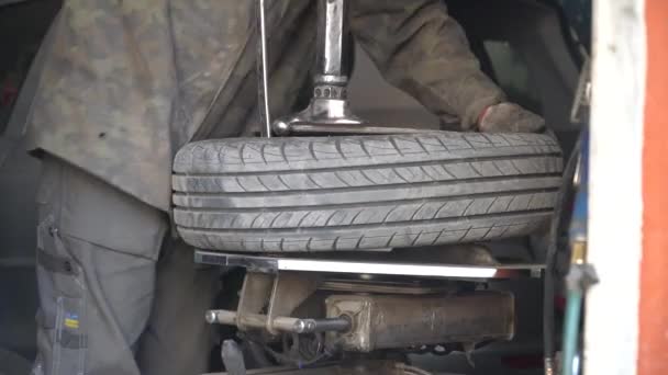 Reifenpanne am Auto durch Mechaniker reparieren. Prozess der Entfernung eines Reifens von einem Leichtmetallrad mit Hilfe einer Reifenmontiermaschine. Winterreifen — Stockvideo