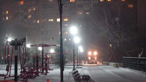 Трактор очистки снега в ночном городе — стоковое видео