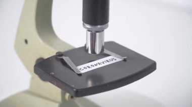 Microscope with virus 2019-n CoV text. CORONAVIRUS in Wuhan, China