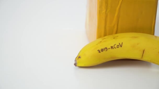 Banana with CORONAVIRUS text and package from China. Virus 2019-n CoV in Wuhan — Stock Video