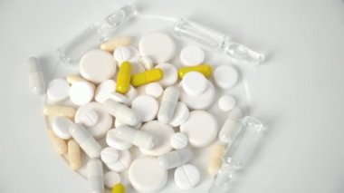 Multi-colored tablets on white background. Making tablets, pills and other medications. Pharmaceutical industry