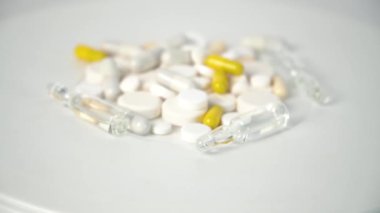 Multi-colored tablets on white background. Making tablets, pills and other medications. Pharmaceutical industry