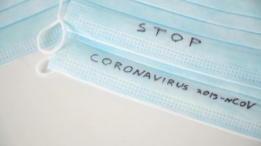 Surgical mask protective mask with STOP CORONAVIRUS text. Virus 2019-n CoV in Wuhan, China
