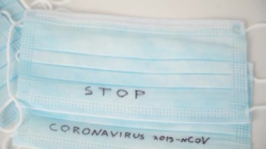 Surgical mask protective mask with STOP CORONAVIRUS text. Virus 2019-n CoV in Wuhan, China