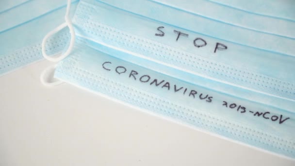 Surgical mask protective mask with STOP CORONAVIRUS text. Virus 2019-n CoV in Wuhan, China — ストック動画