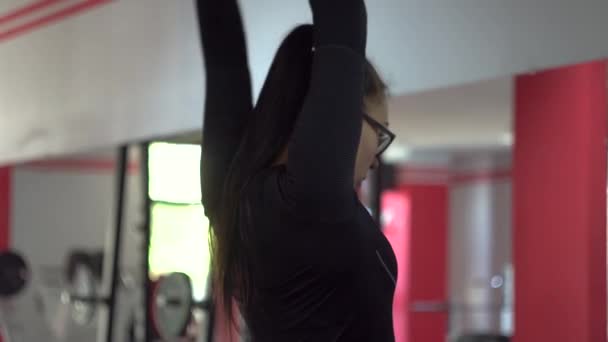 Schönes Mädchen mit Brille beim Sportverein macht andere Übungen — Stockvideo
