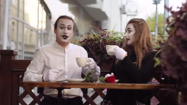 Two happy mime on a date drink coffee in the cafe. Romantic date — Stock Video