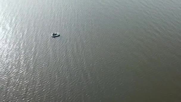 无人驾驶飞机在湖上的一艘小渔船上向渔民上空射击。美丽的夏季风景湖。空中景观。无人机飞过美丽的湖面 — 图库视频影像