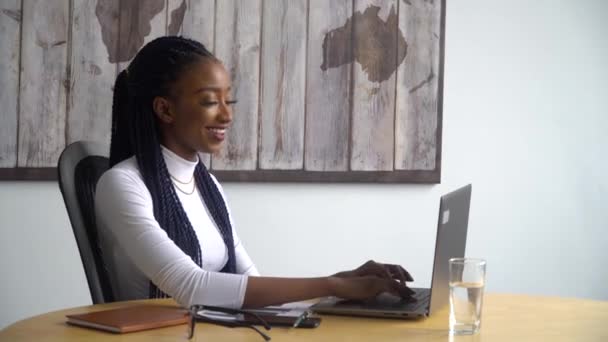 Güzel Afrikalı Amerikalı iş kadını dizüstü bilgisayar kullanıyor. — Stok video