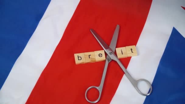 UK flag with the inscription brexit and scissors. Brexit in the UK Stock Footage