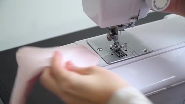 Woman sews a protective mask. making cotton fabric medical mask, virus protection — Stock Video