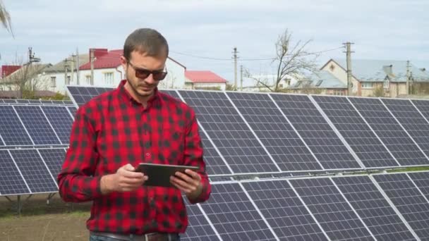 Engenheiro jovem bem sucedido com tablet planejamento futurista painéis solares usina — Vídeo de Stock
