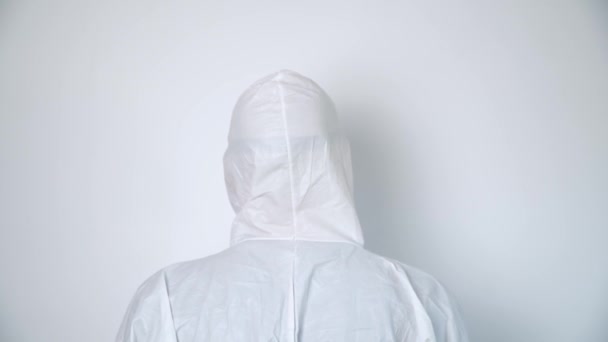 Portrait of a virologist in protective coverall and black mask — Stock Video