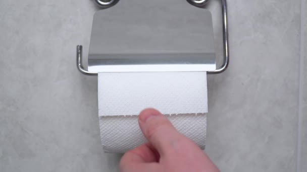 Toilet paper with text diarrhea in wc. A man in a panic tears off toilet paper — Stock Video