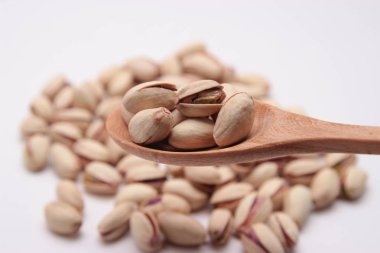 Tahta kaşıkla blury yığın arka plan üzerinde fıstıklı fasulye. 