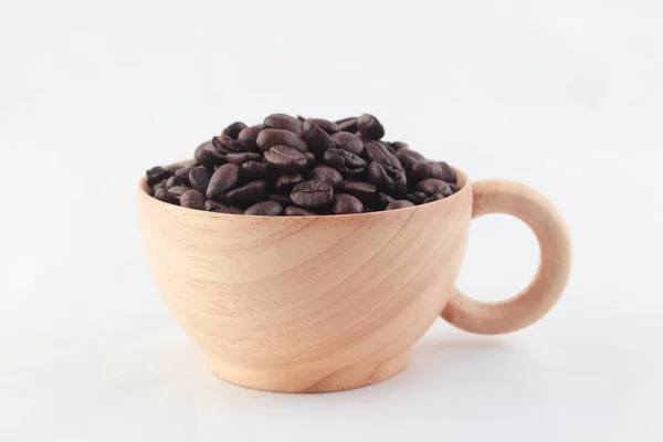 Изолировать кофейных зерен в деревянной чашке белого фона — стоковое фото