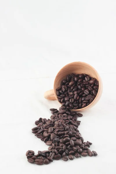 Isolare chicchi di caffè in tazza di legno su sfondo bianco — Foto Stock