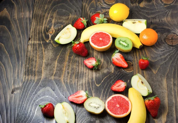 Fresh organic fruits on wooden table — Stock Photo, Image