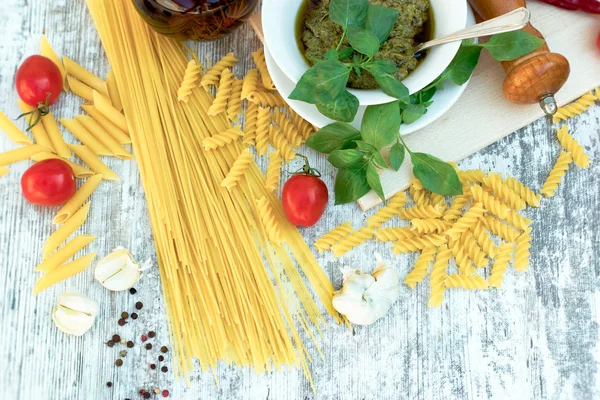 Homemade basil pesto sauce on rustic wooden table — Stock Photo, Image