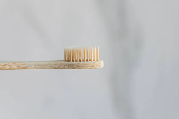 Toothbrush made of eco-friendly material: bamboo and wood. A major bristle plan on a white background.
