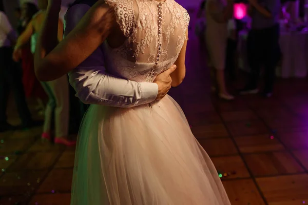 Newlyweds dance at the wedding banquet. Darkness and romantic.