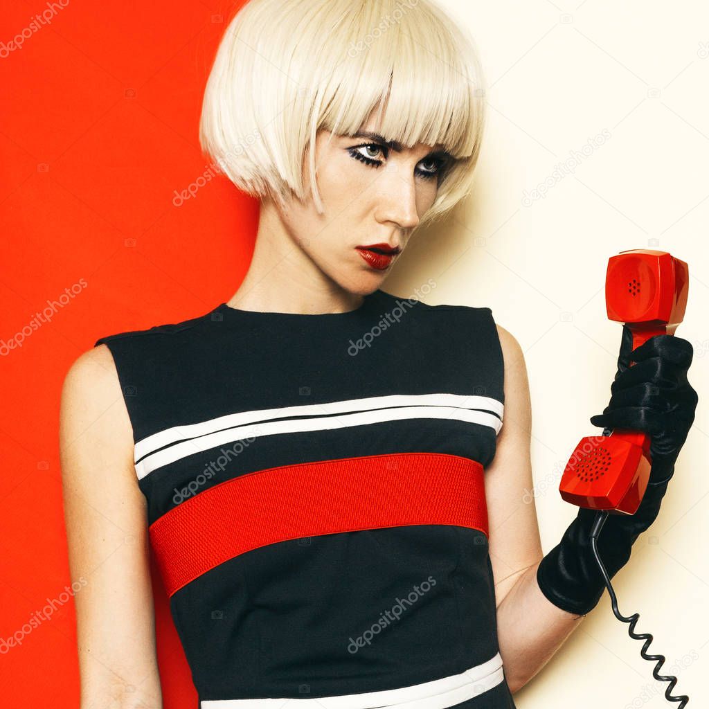 Blonde Sexy retro style with vintage phone and vintage clothing.