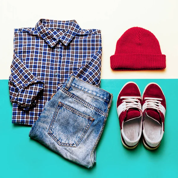 Urban clothing set. Plaid shirt, jeans, shoes cap