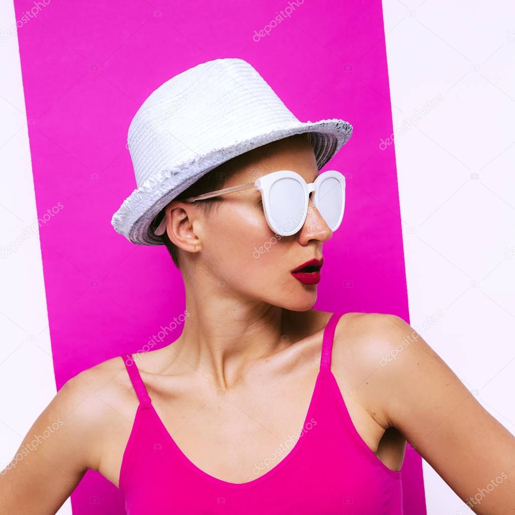 Stylish Girl in sunglasses and hat. Minimal pop art beach fashio