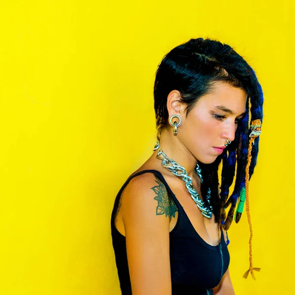 Cool Colombia girl with dreadlocks and piercings over colorful y — Stock Photo, Image