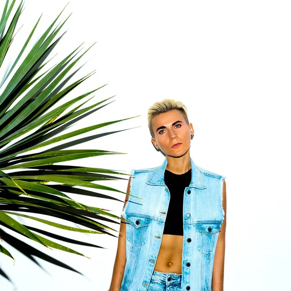 Girl in a stylish denim outfit against a white wall — Stock Photo, Image