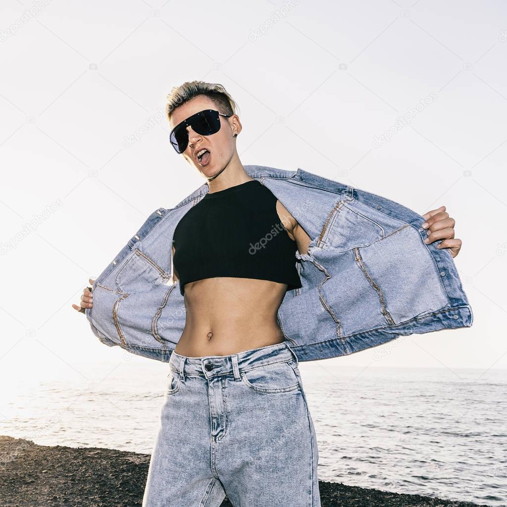 girl in stylish denim outfit sea background