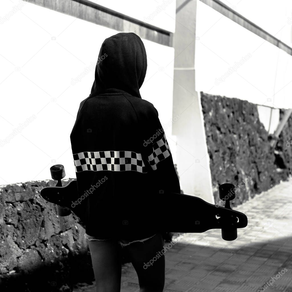 Teen girl hip hop style. Hoodie. Urban street fashion. Skateboar